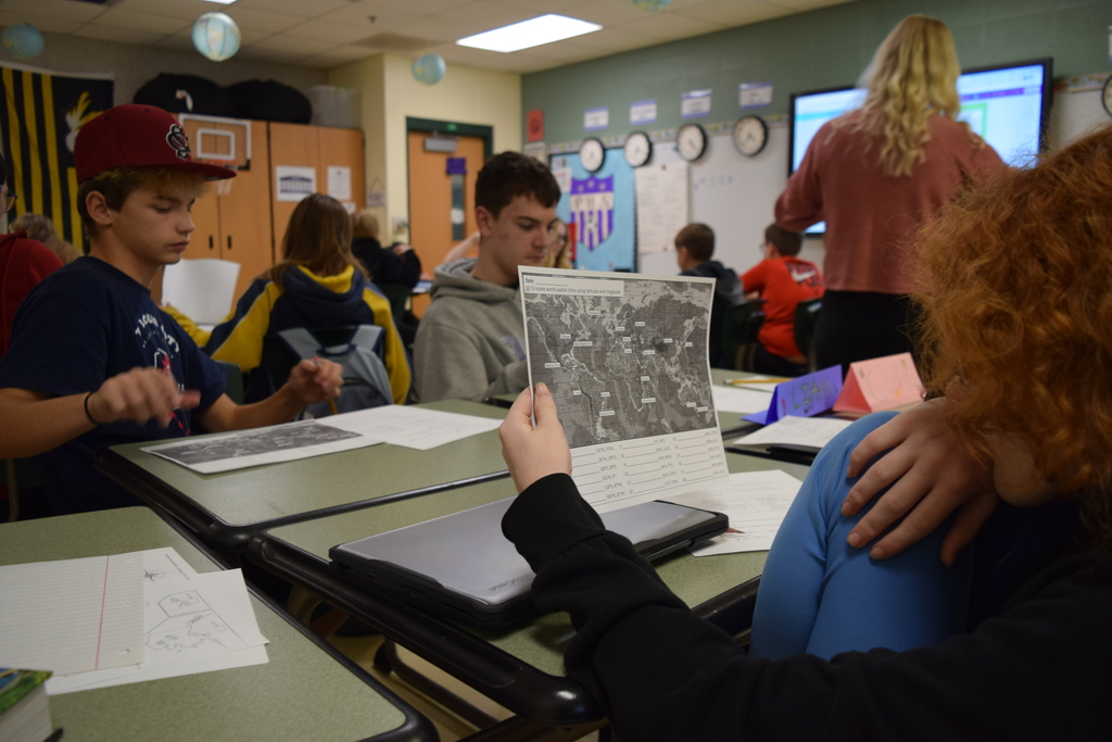 Photo shows students in Mrs. Vogt’s 7th grade English language arts classes writing letters for veterans participating in the Honor Flight program