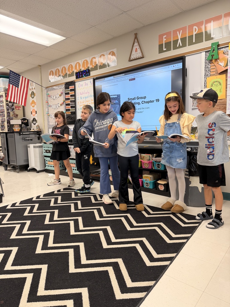 The photo shows third grade students at Zitzman Elementary performing readers theater