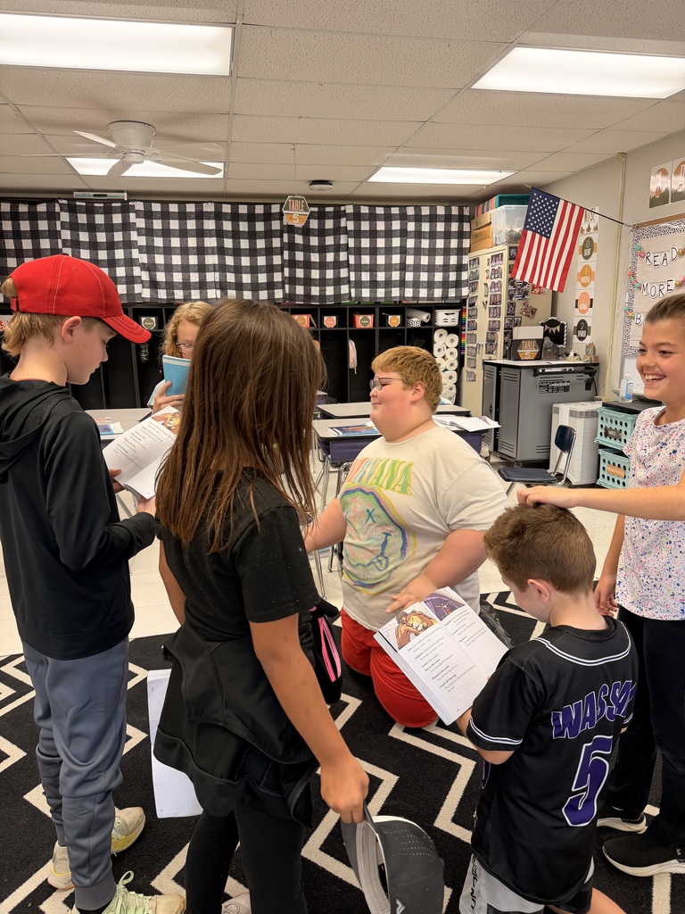 The photo shows third grade students at Zitzman Elementary performing readers theater