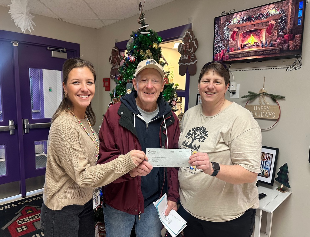 The photo shows a check from Masonic Home being presented to Robertsville Elementary and Nike Elementary