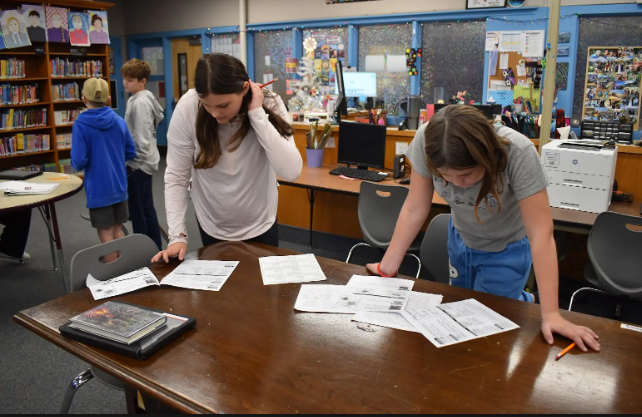 Photo shows students in the Pacific Intermediate library learning nonfiction text features 