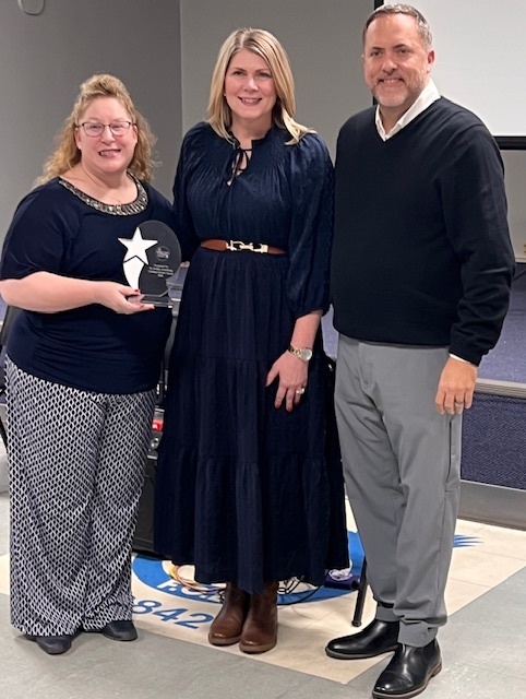 The photo shows the Pacific Chamber of Commerce honoring an outstanding leader from our school community