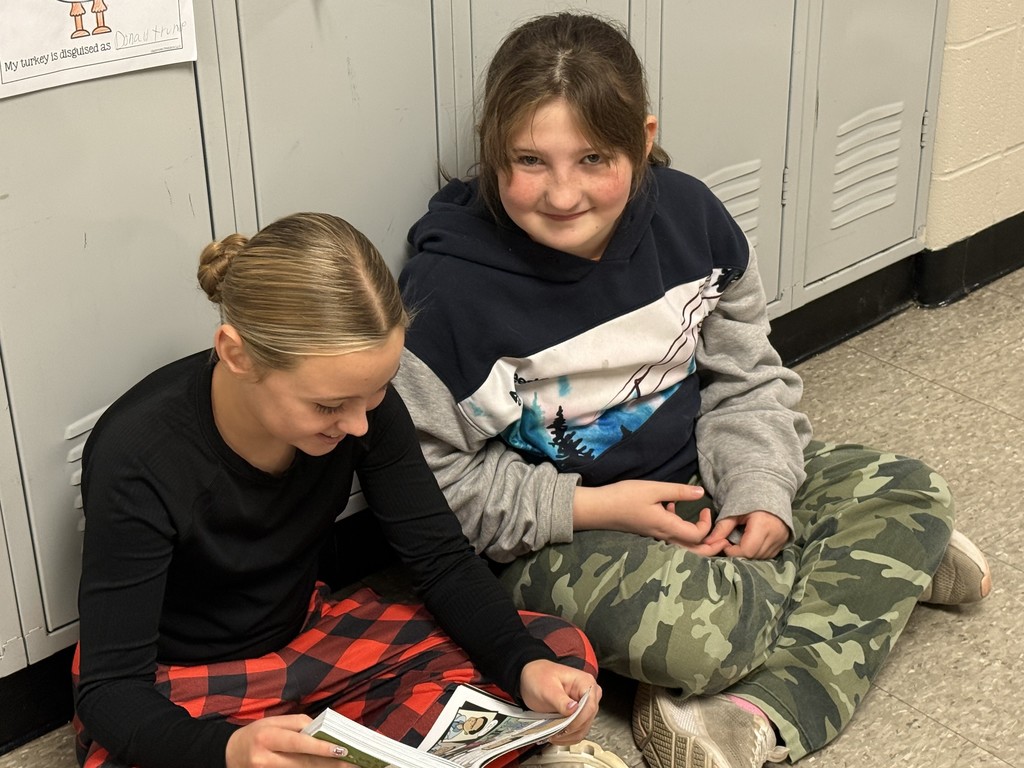 Photo shows partner reading at the 6th grade level