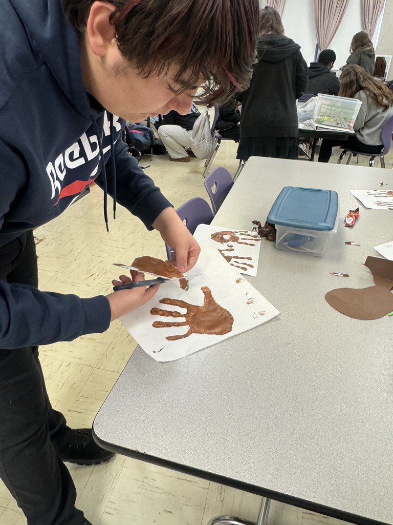 The photo shows PHS Child Development students learning about the difference between process art and product art in children.