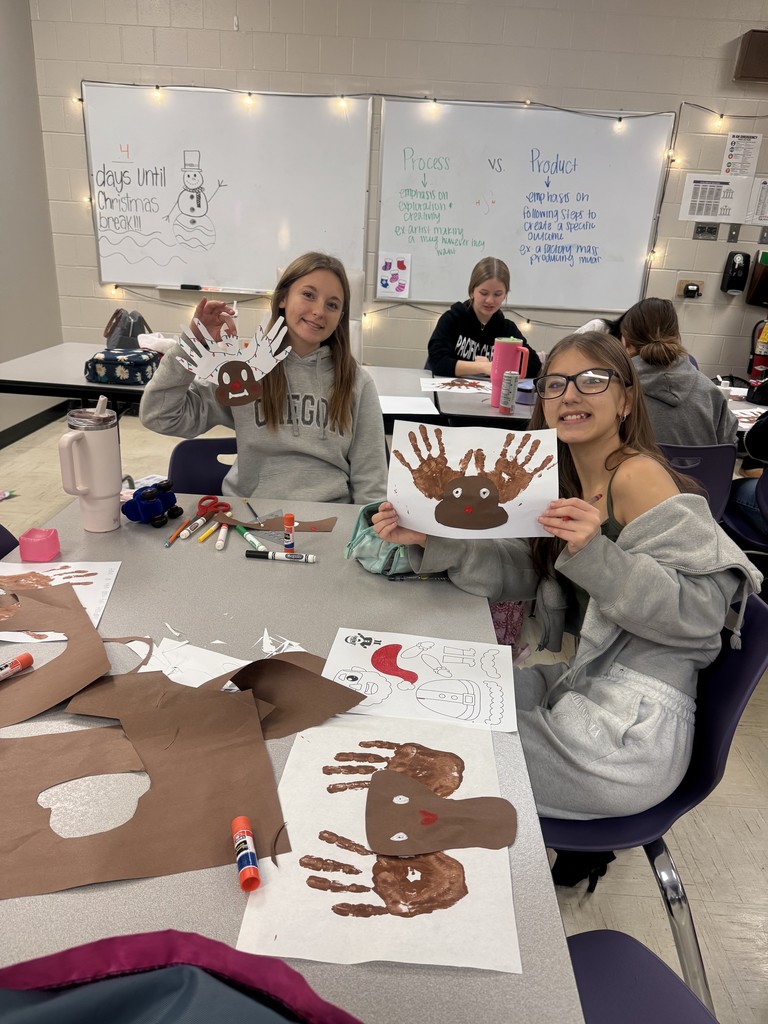 The photo shows PHS Child Development students learning about the difference between process art and product art in children.