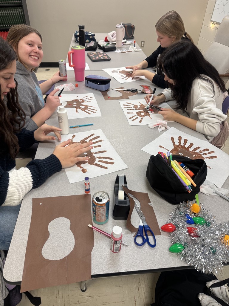 The photo shows PHS Child Development students learning about the difference between process art and product art in children.