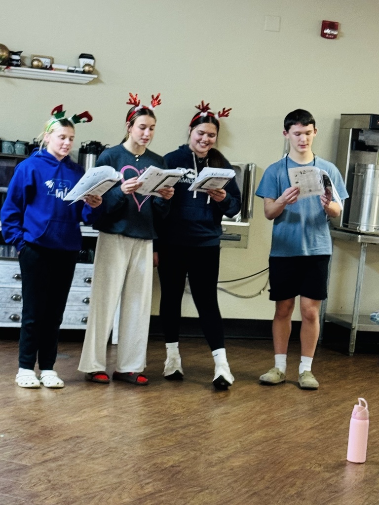 The photo shows Riverbend Middle School students in the Exploring Community Service class spreading holiday cheer throughout the community