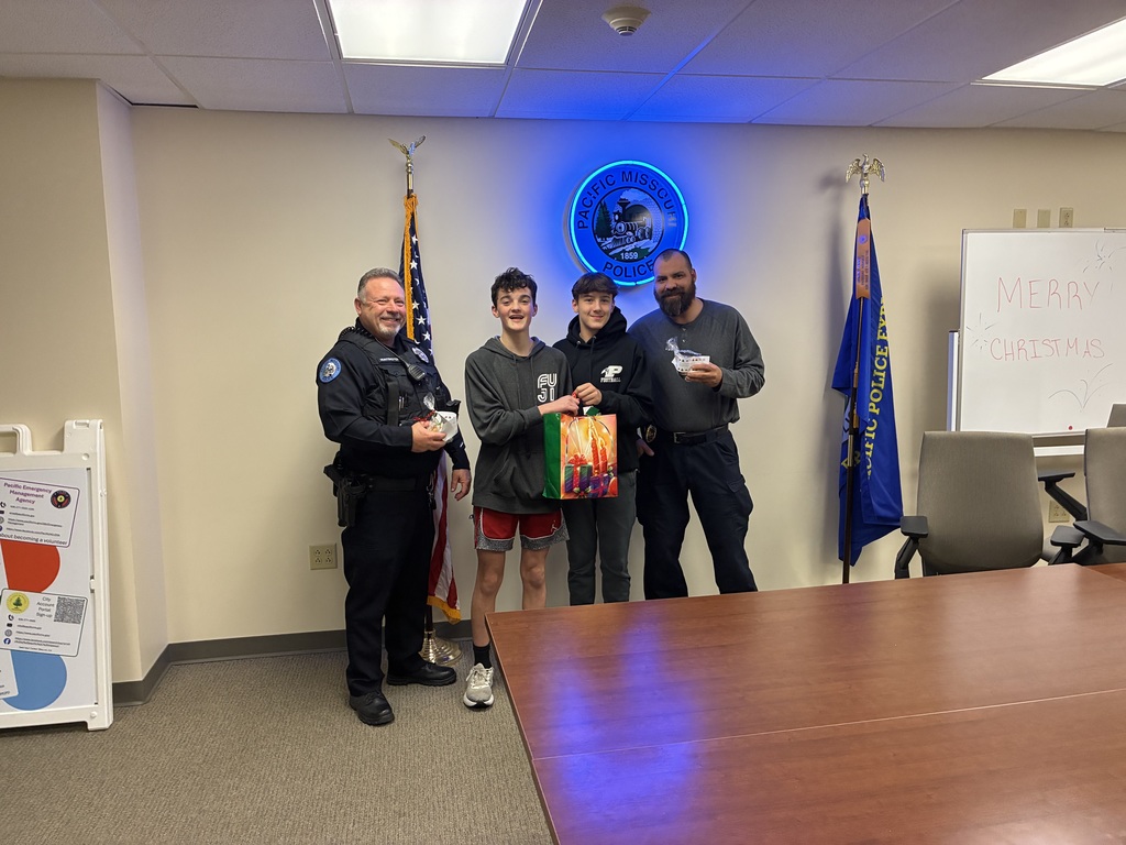 The photo shows Riverbend Middle School students in the Exploring Community Service class spreading holiday cheer throughout the community