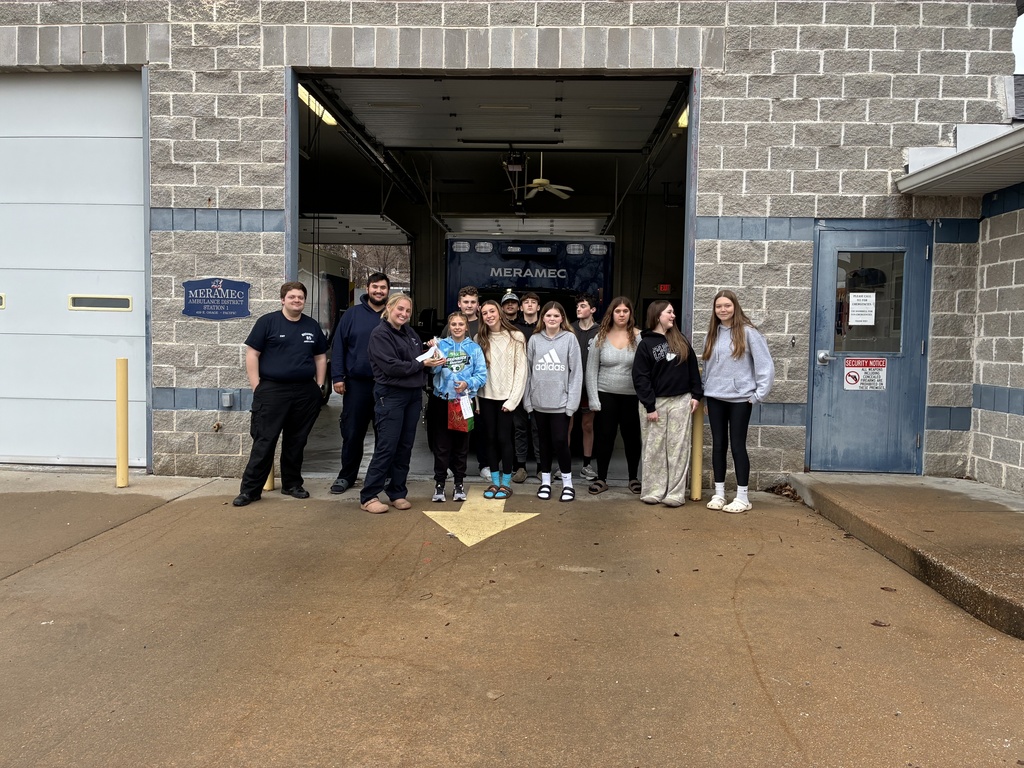The photo shows Riverbend Middle School students in the Exploring Community Service class spreading holiday cheer throughout the community