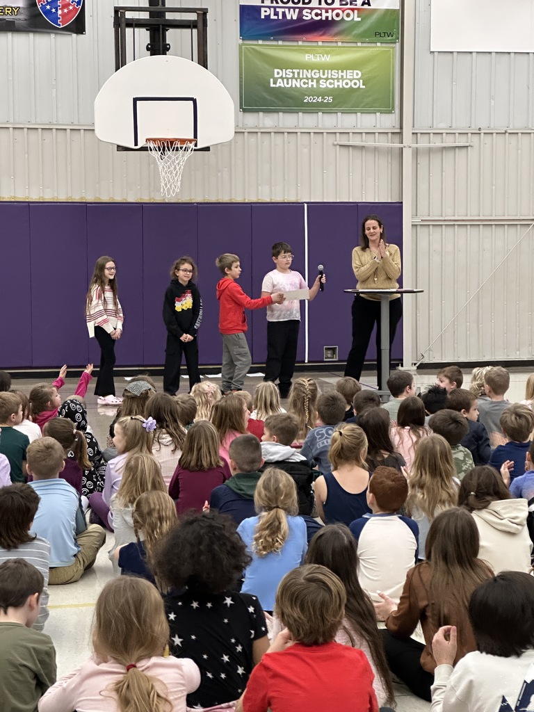 Presenting awards to classrooms. 