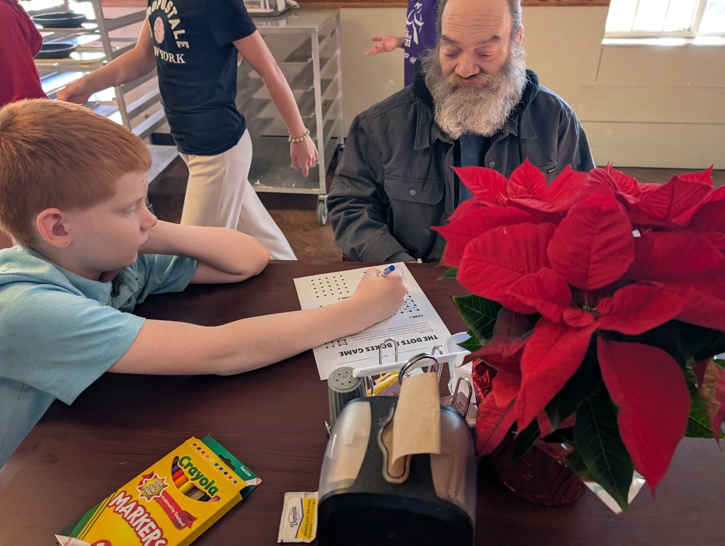 The photo shows the Pacific Intermediate JAG Club and 5th grade choir students spreading holiday cheer at the Pacific Care Center