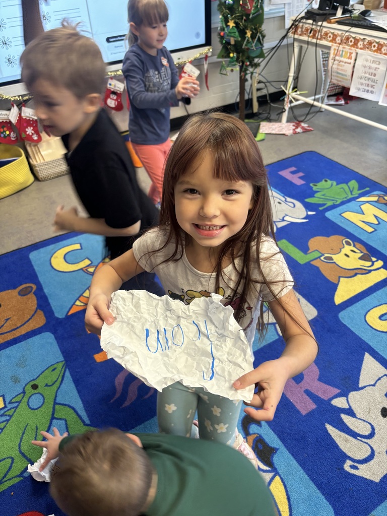 The photo shows kindergarten students at Coleman Elementary practicing their sight words with a fun snowball activity