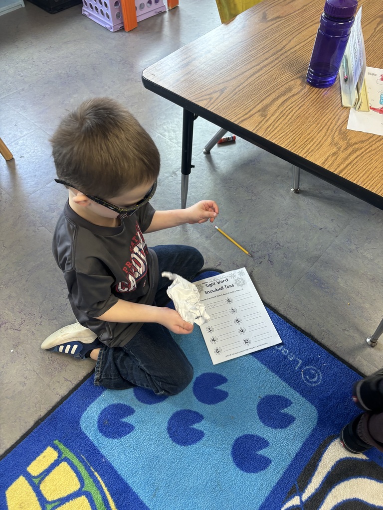 The photo shows kindergarten students at Coleman Elementary practicing their sight words with a fun snowball activity