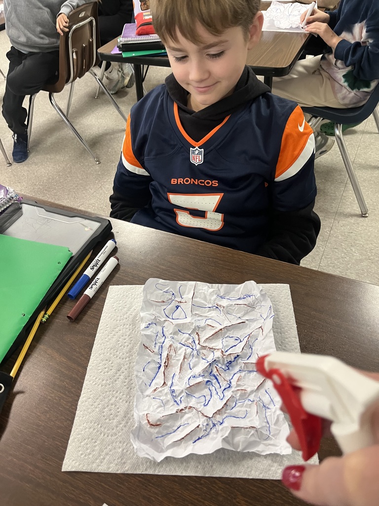 The photo shows Pacific Intermediate 5th graders learning about erosion with a hands-on activity