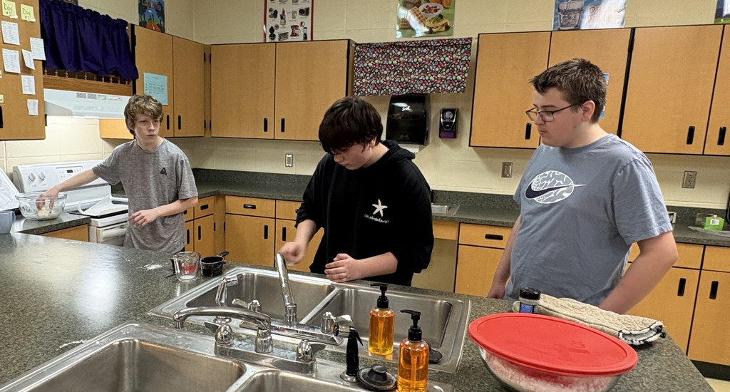 Middle School students practicing kitchen safety. 