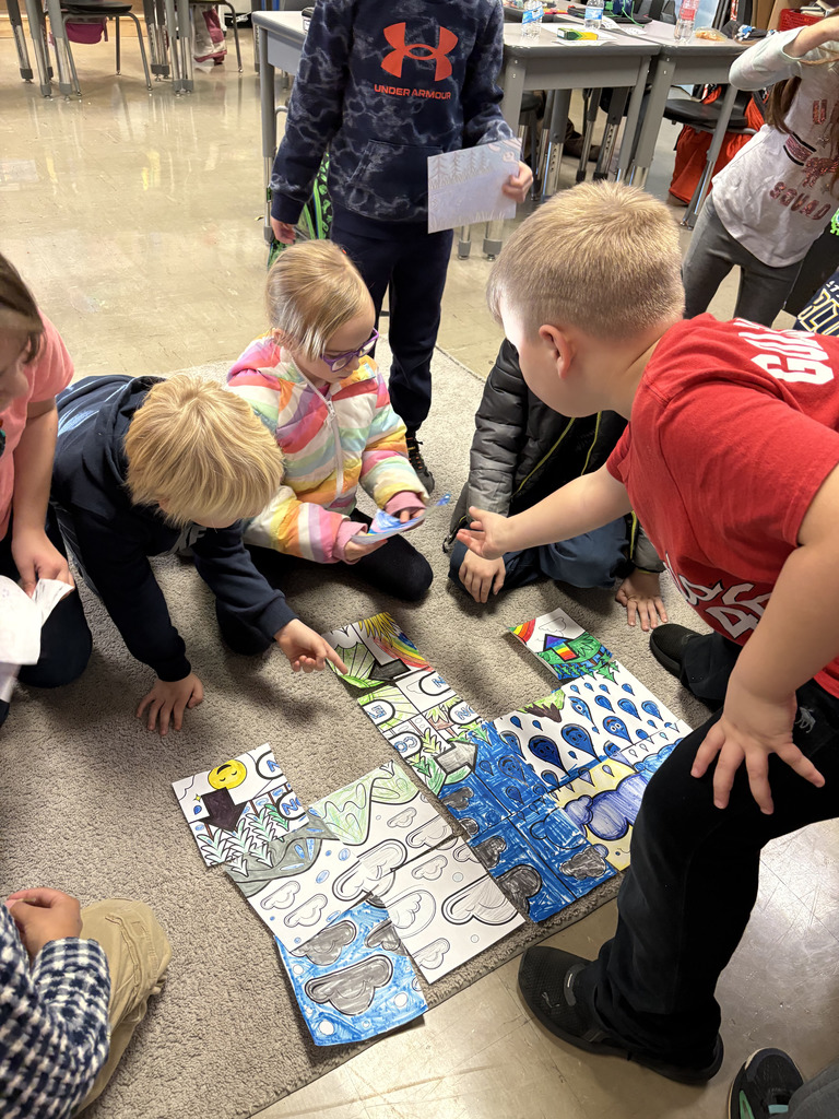 Students working on a collaborative water cycle poster.