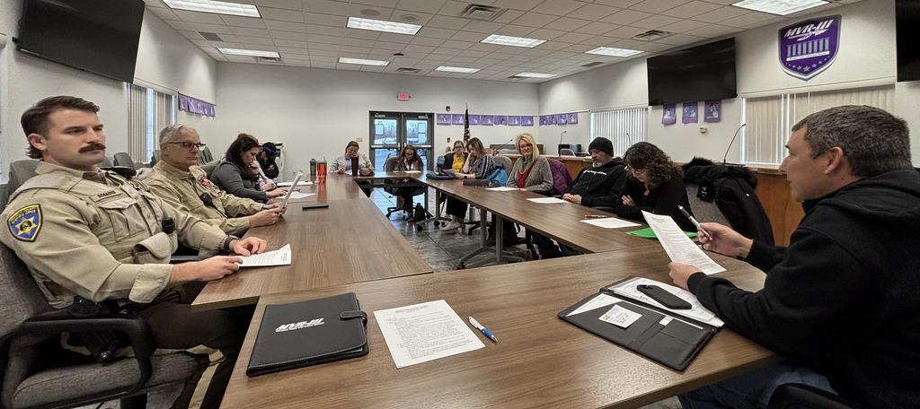 MVR-III District Safety Committee discussing around table.