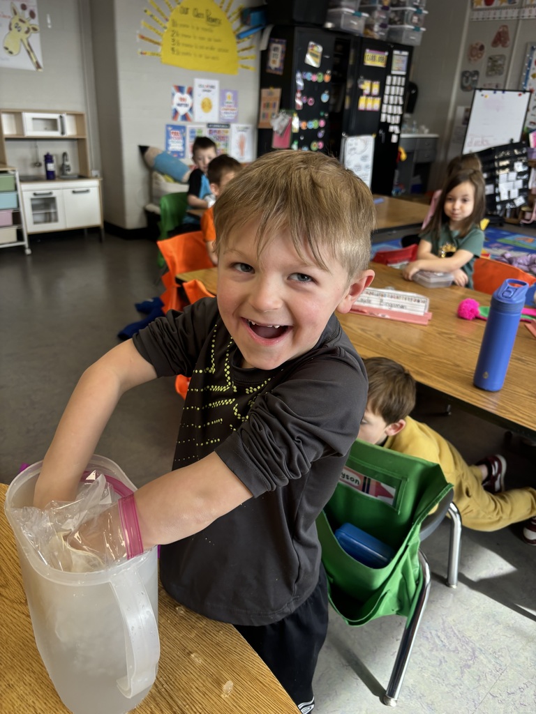 Students using a “blubber” layer by placing one hand in a glove inside a sealed bag.