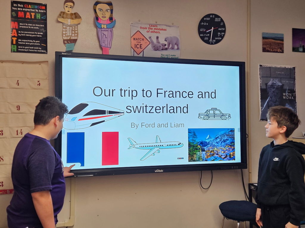 Students presenting a trip to France and Switzerland presentation.
