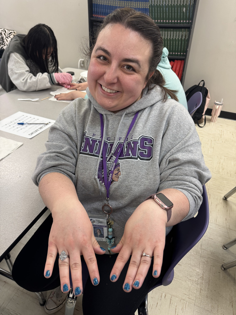Staff member showing her nails after manicure. 