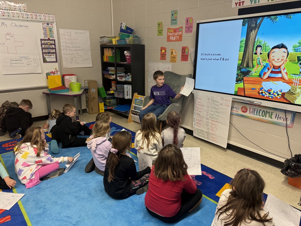 Students listening to a book on the computer screen.