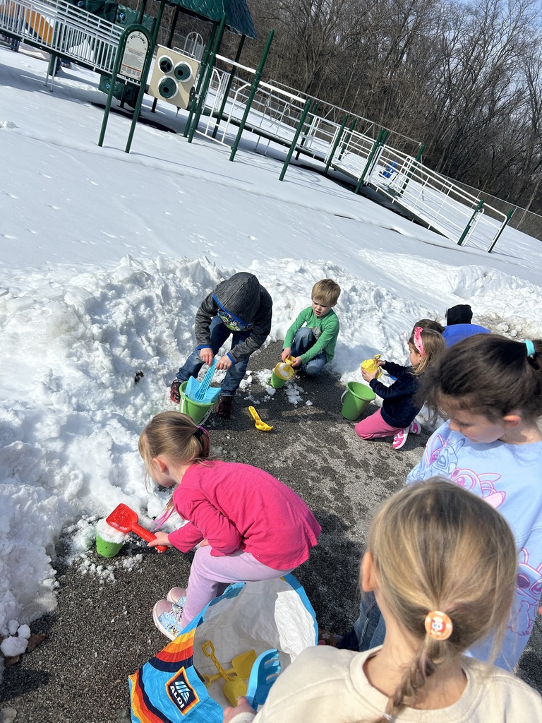Students shoveling snow into buckets.