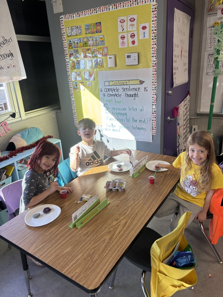 Elementary students working on painting rocks.