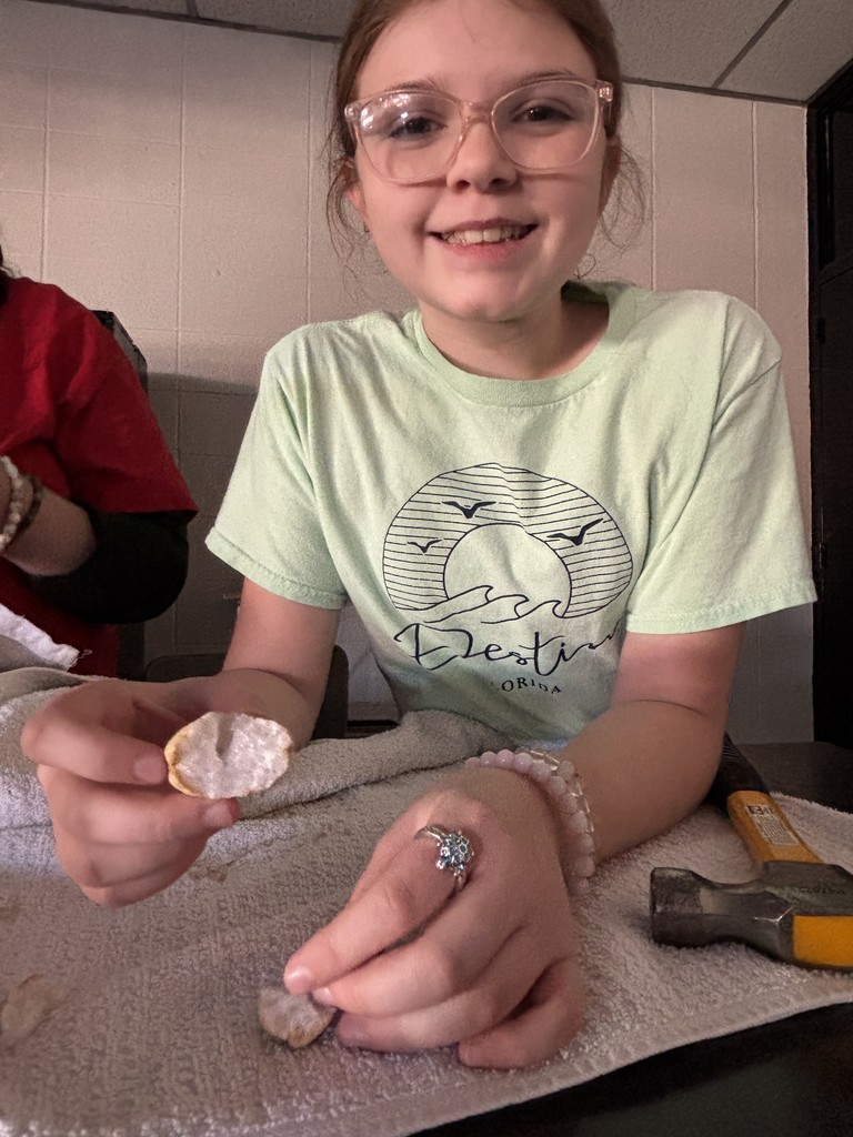 Student holding a cut open geode. 