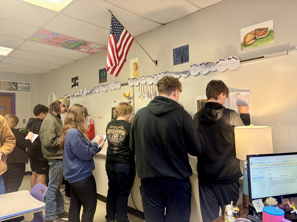 Students examining a piece of art in their fine arts gallery.