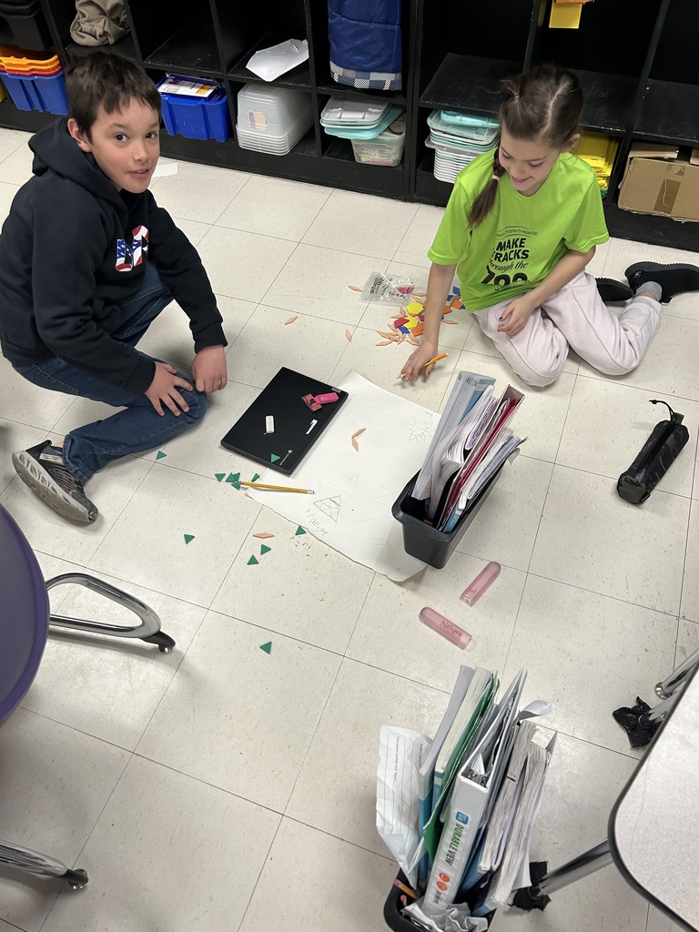 Students working with shape blocks in an activity. 