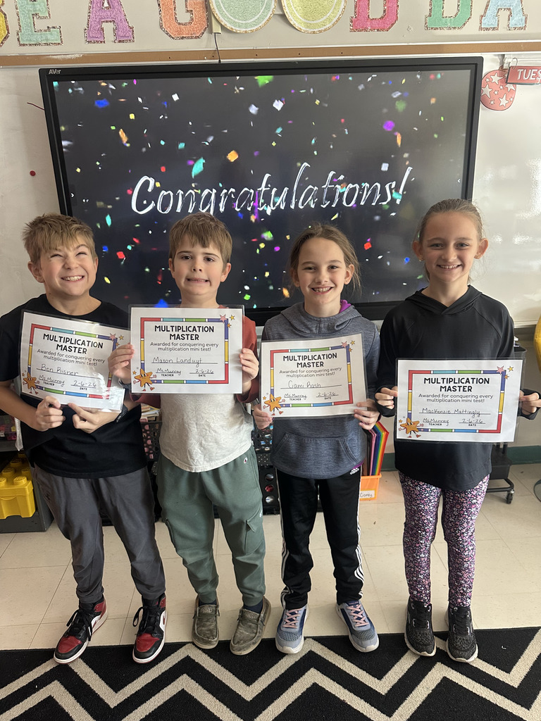 Elementary students holding certificates.