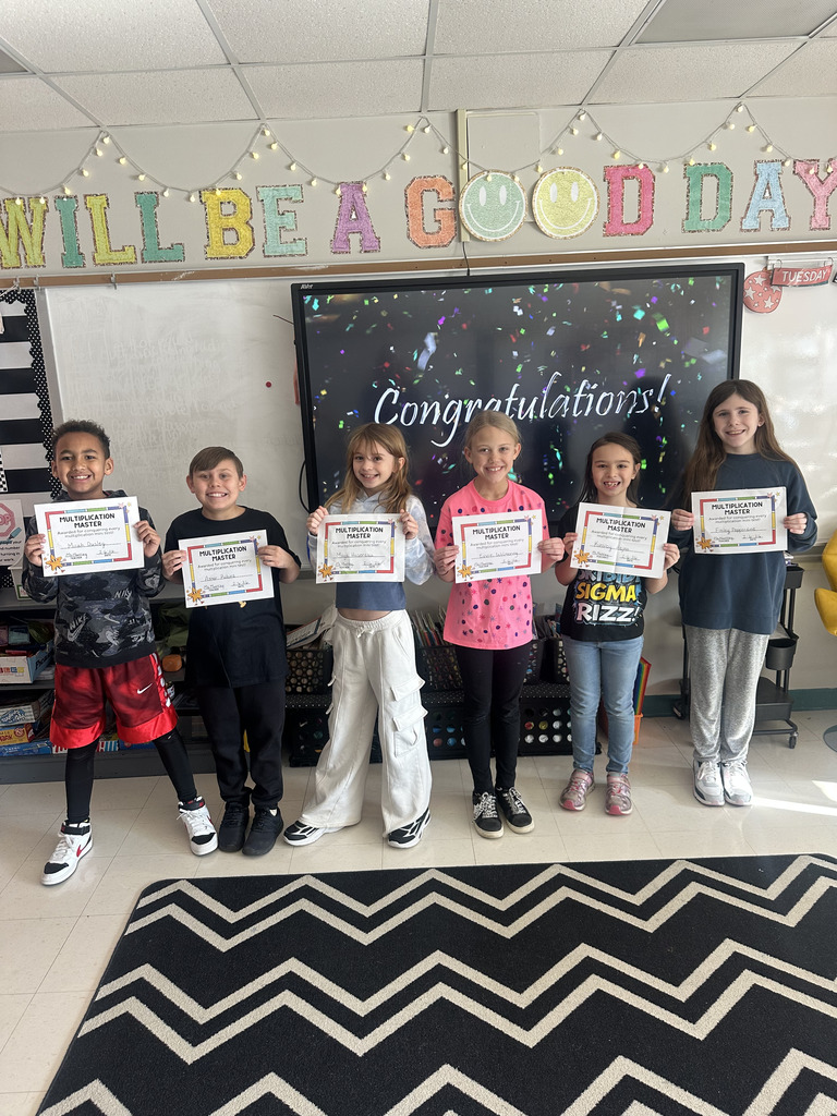 Elementary students holding certificates.