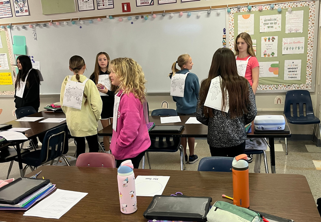 Students learning about Earth's rotation in classroom activity. 