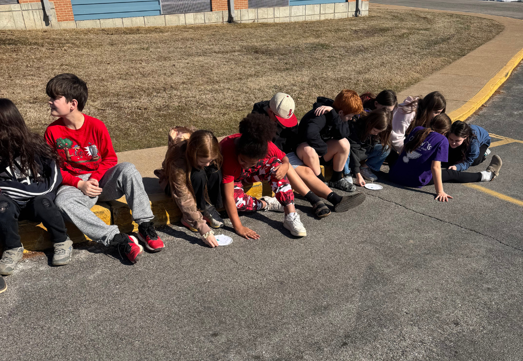 Students exploring school project outside. 