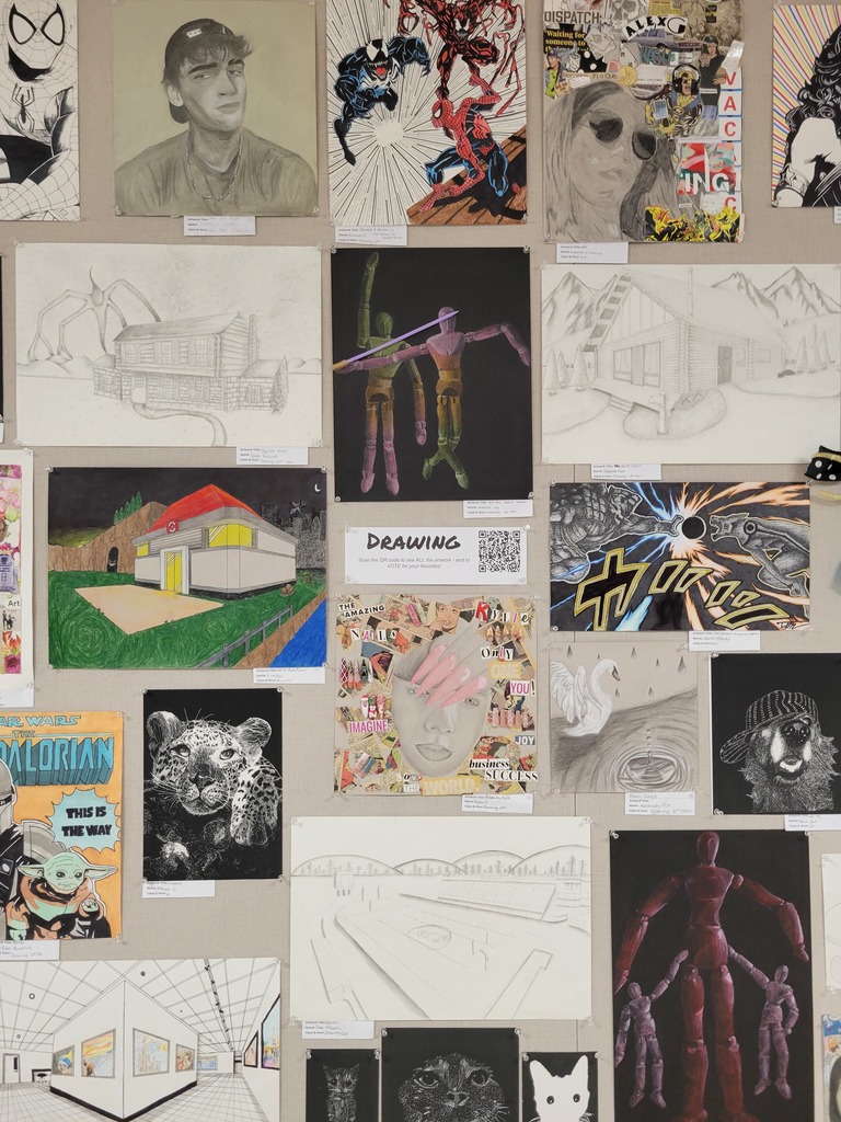 Various student artwork on wall.
