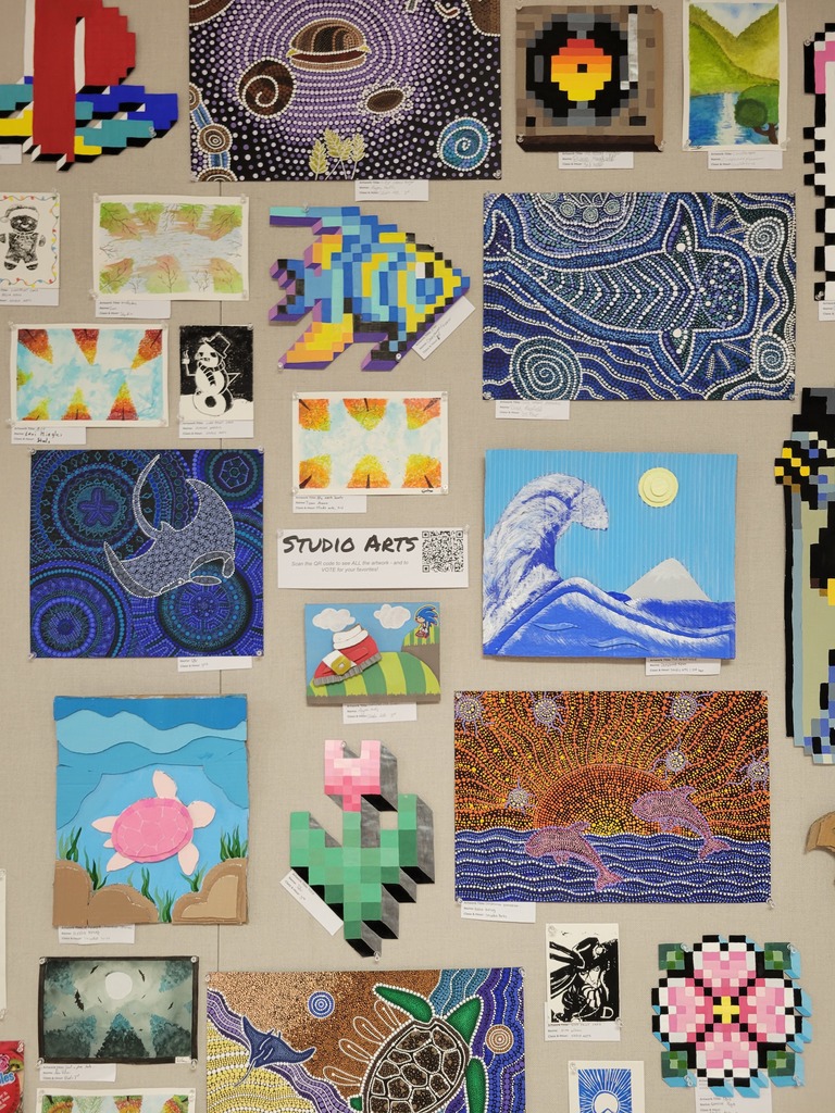 Various student artwork on wall.