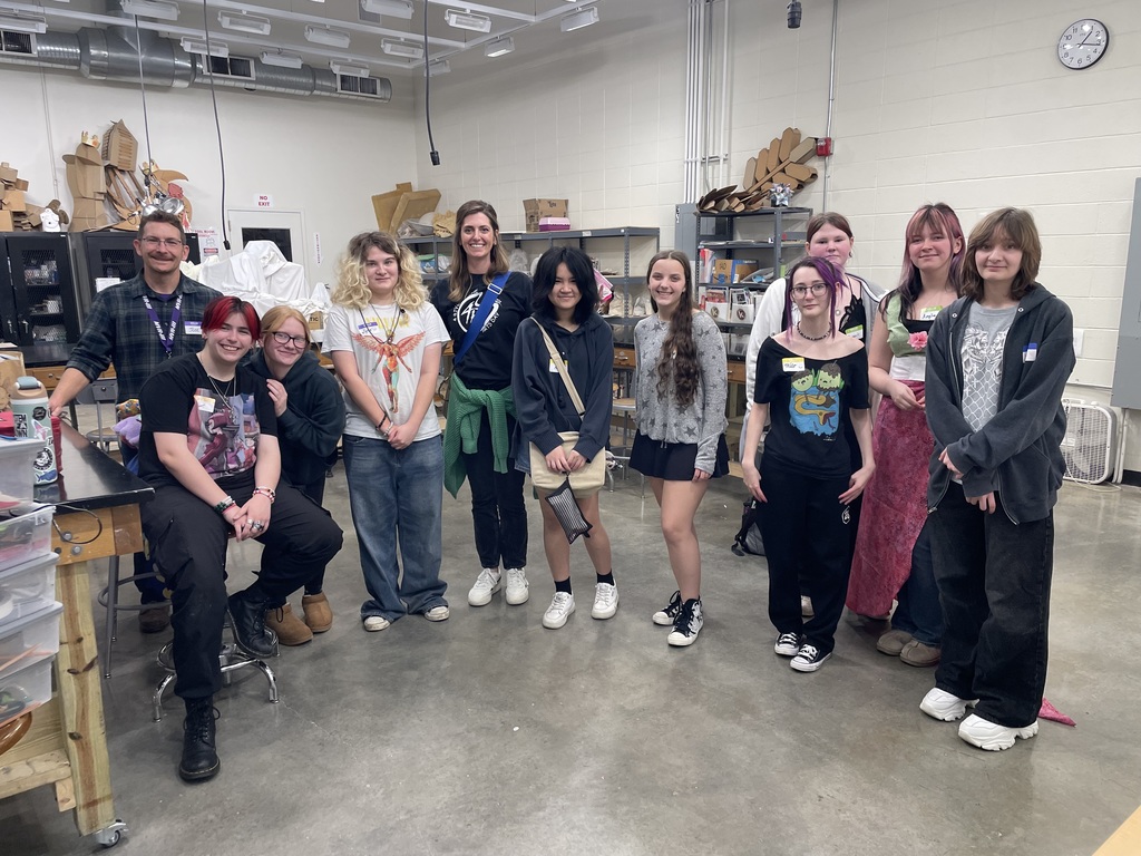 Group photo of students in an art room.
