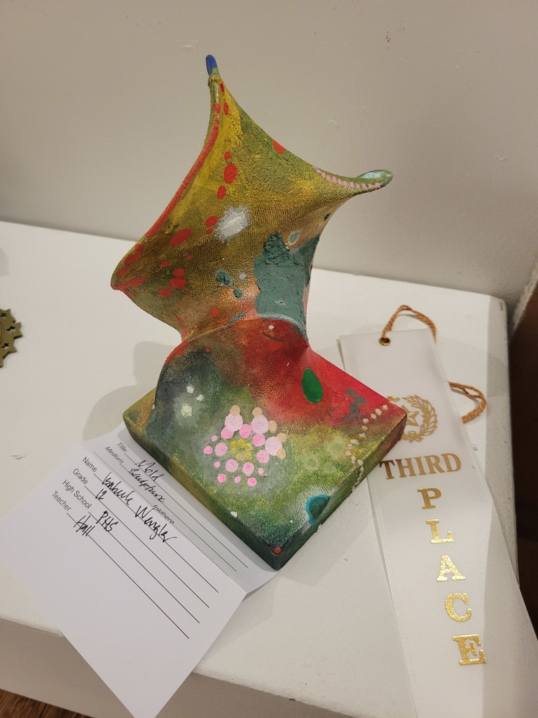 A colorful piece of art titled, "Mold," with a third place ribbon beside it.