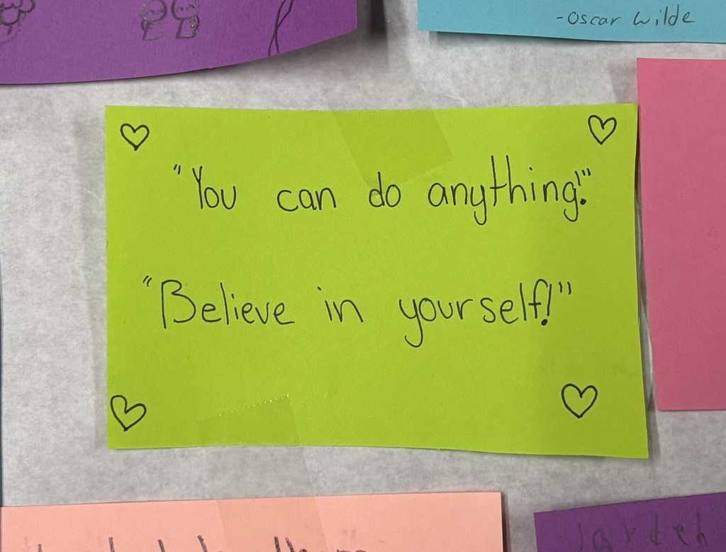 Bright green sticky note with encouraging messages saying, “You can do anything” and “Believe in yourself!”