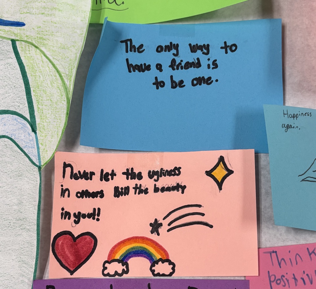 Close-up of colorful sticky notes with positive messages and drawings promoting kindness, friendship, and self-worth.