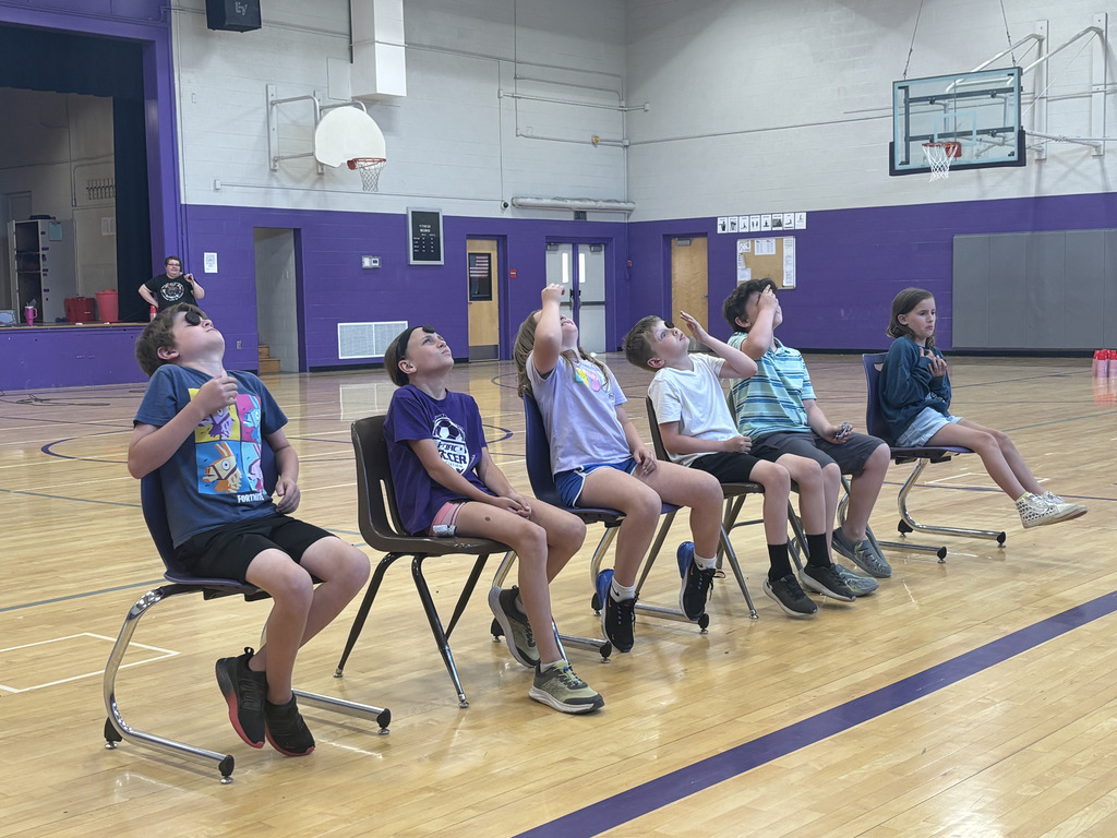 Students playing a game in an indoor school gym.