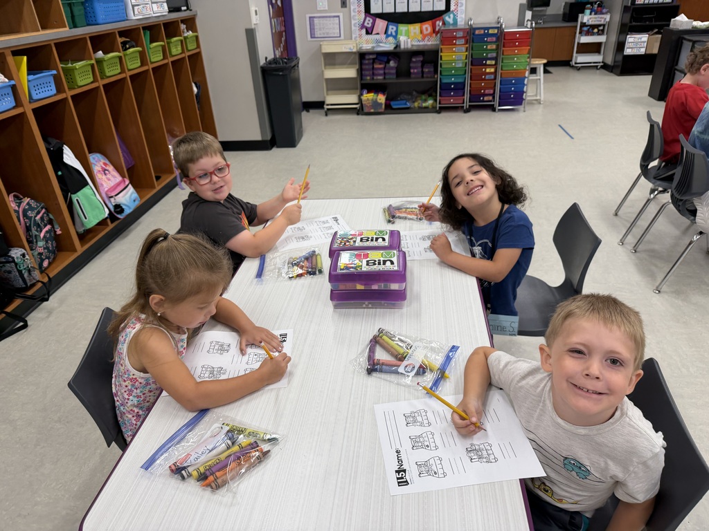 Students working on craft projects in a school classroom.
