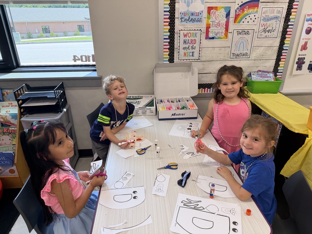 Students working on craft projects in a school classroom.