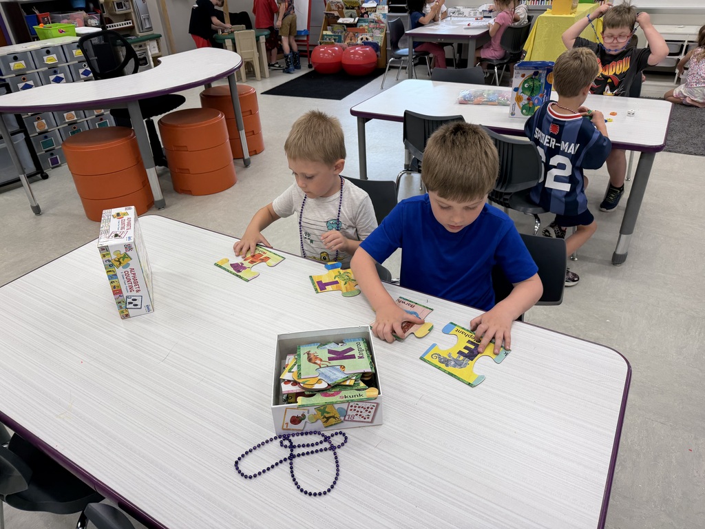 Students working on craft projects in a school classroom.