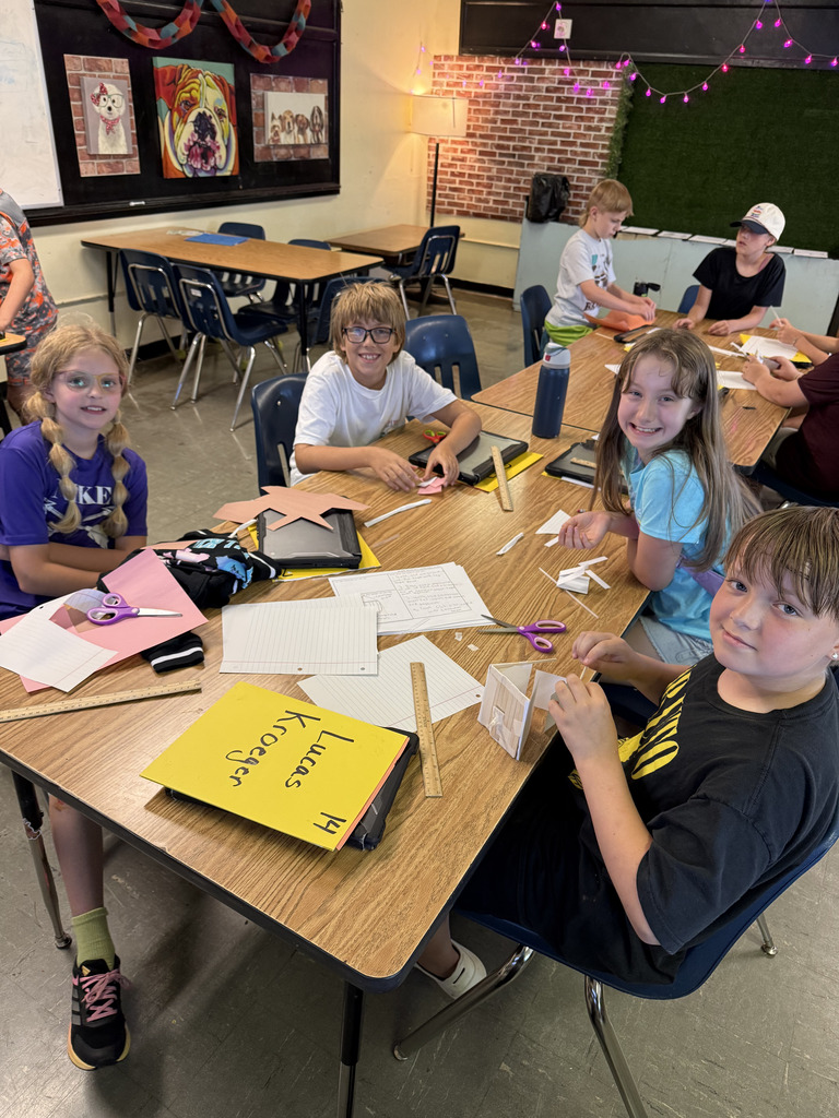 Students working on craft projects in a school classroom.