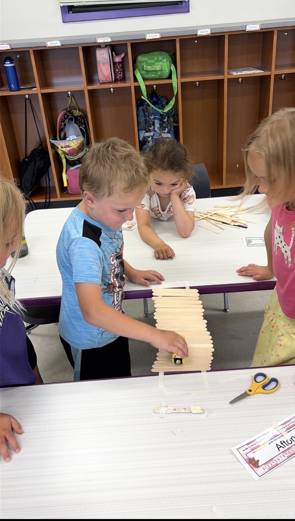 Young students working on a craft project in groups.