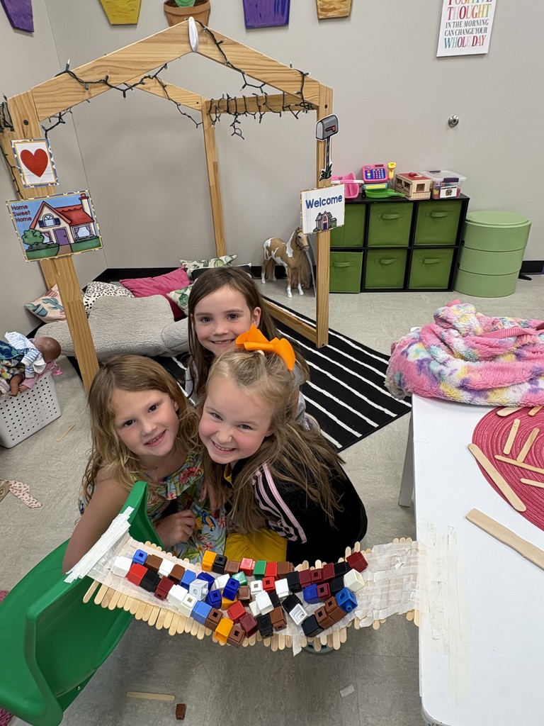 Young students working on a craft project in groups.