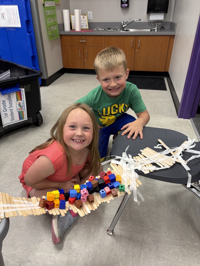 Young students working on a craft project in groups.