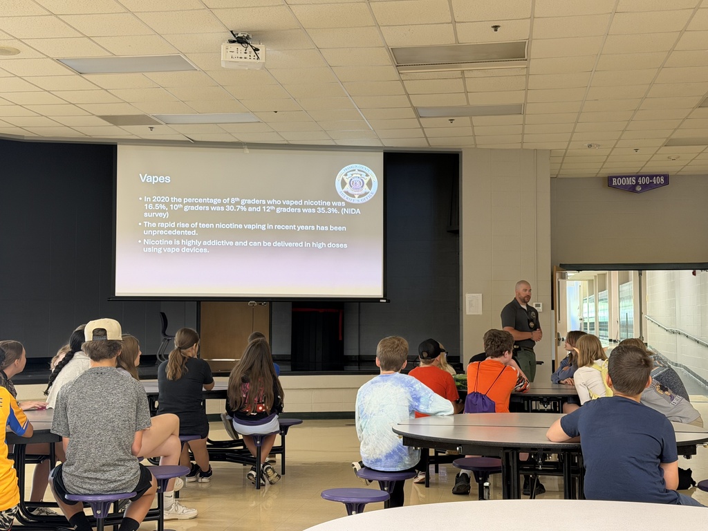 Middle school students attend a presentation on the dangers of vaping and meet a law enforcement K-9 during a school safety and awareness program.