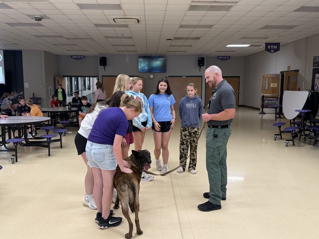 Middle school students attend a presentation on the dangers of vaping and meet a law enforcement K-9 during a school safety and awareness program.
